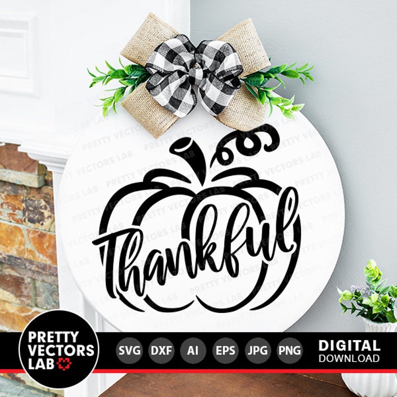May include: A white round sign with a black pumpkin outline and the word "Thankful" written in a decorative script font. A brown and black checkered bow with green leaves is attached to the top of the sign.
