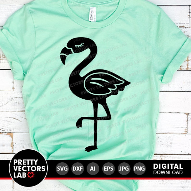 May include: A black silhouette of a flamingo with one leg raised, standing on a light green t-shirt. The t-shirt is a blank canvas for a design.