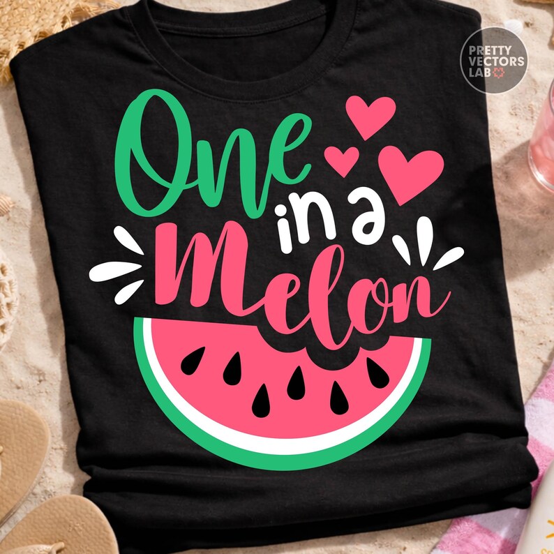 May include: A black short-sleeved t-shirt featuring the text One in a Melon in green and pink script and block lettering. The design includes three pink hearts and a graphic of a watermelon slice with black seeds at the bottom of the shirt.