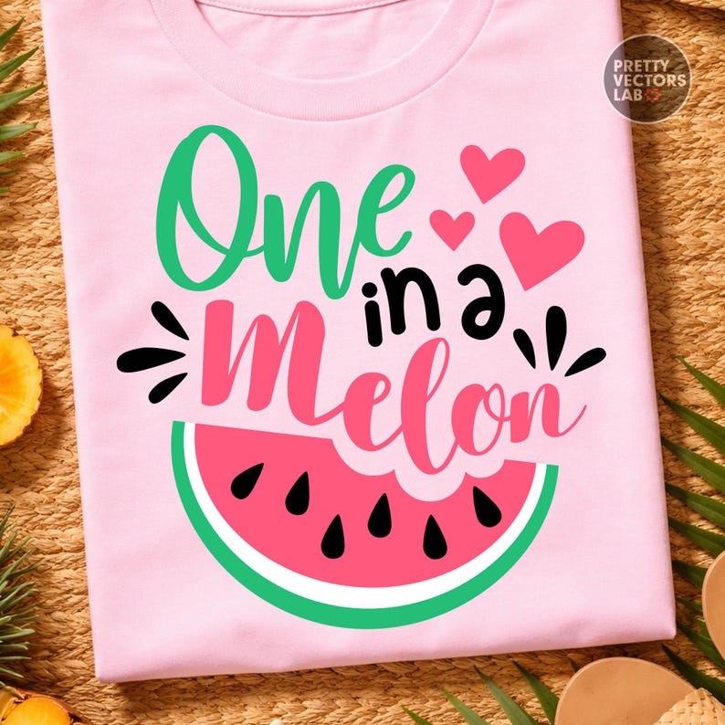 May include: A light pink t-shirt featuring a graphic design with the text One in a Melon in green and pink script and block lettering. The design includes three pink hearts and a stylized watermelon slice with black seeds and a green rind.