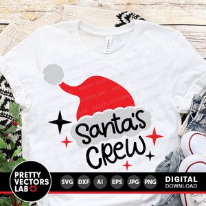 May include: White t-shirt with a red and white Santa hat graphic and the text "Santa's Crew".