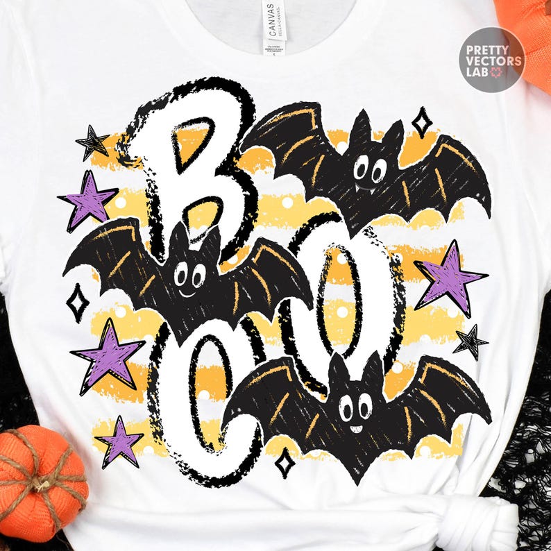 May include: A white t-shirt featuring a graphic print with the word BOO in large black outlined letters. The design includes three black bats with white eyes and several purple stars over a background of horizontal yellow and white stripes.