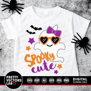 May include: A white t-shirt with a cute ghost wearing sunglasses and a purple bow. The ghost is surrounded by stars and bats. The text "Spooky cute" is written in orange and purple letters.