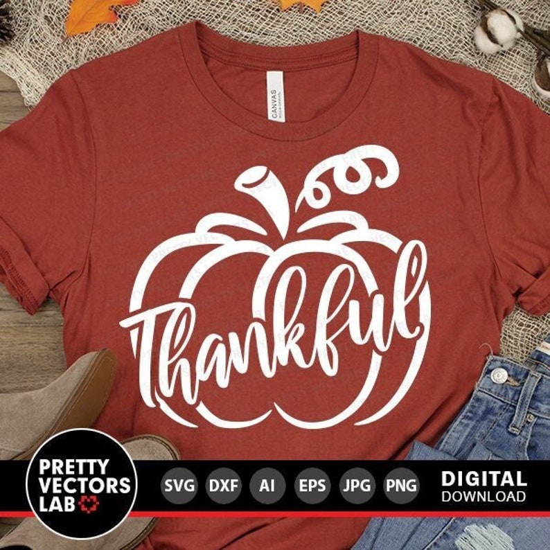 May include: A red t-shirt with a white pumpkin design and the word "thankful" inside the pumpkin. The design is perfect for fall and Thanksgiving.