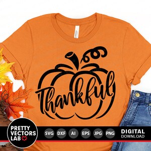 May include: Orange t-shirt with a black pumpkin design and the word "thankful" inside the pumpkin.