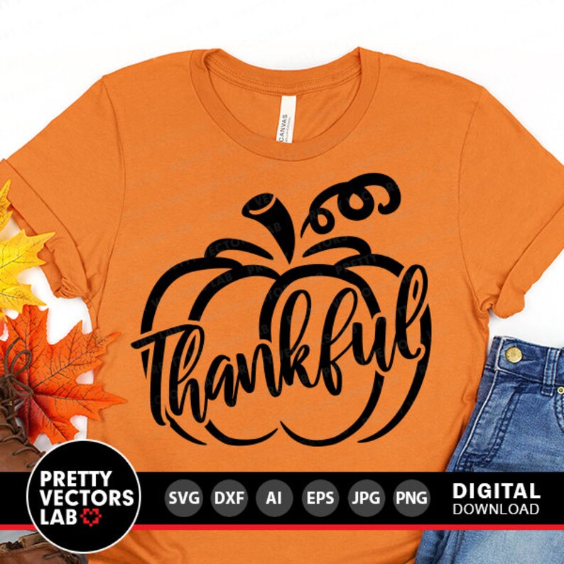 May include: Orange t-shirt with a black pumpkin design and the word "thankful" inside the pumpkin.