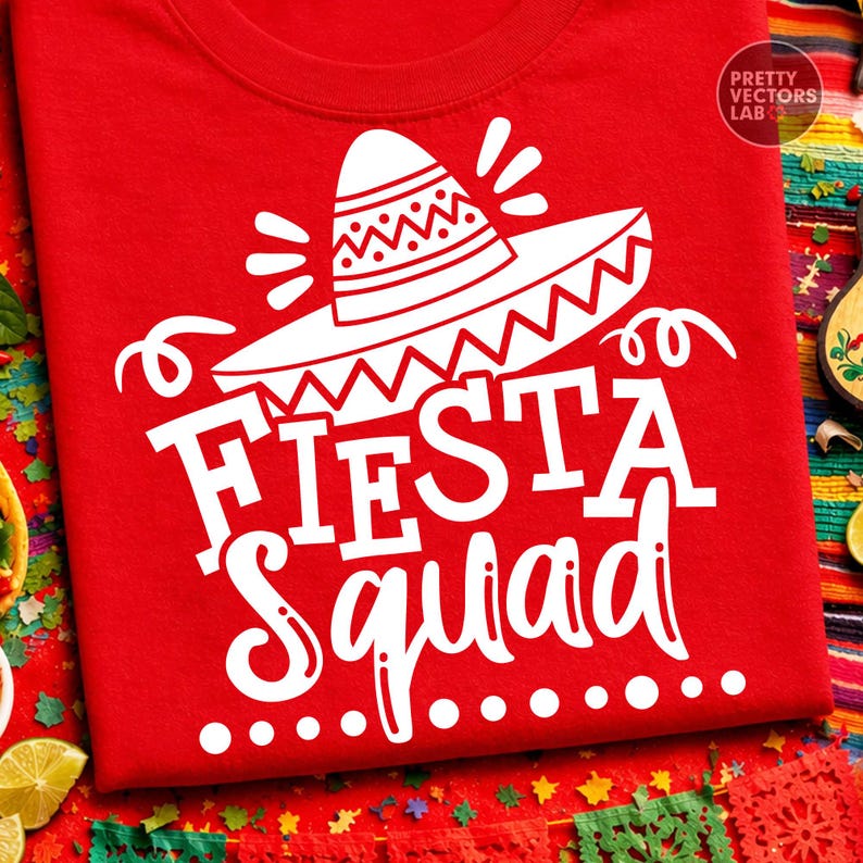 May include: Red t-shirt with a white sombrero graphic and the words "Fiesta Squad". The design includes decorative elements and is likely for a festive occasion. The shirt is made of a soft material.