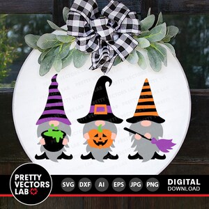 May include: Three gnomes dressed in Halloween costumes. The gnome on the left is wearing a purple and black striped hat and holding a cauldron. The gnome in the middle is wearing a witch's hat with a purple band and holding a jack-o-lantern. The gnome on the right is wearing a black and orange striped hat and holding a broom.