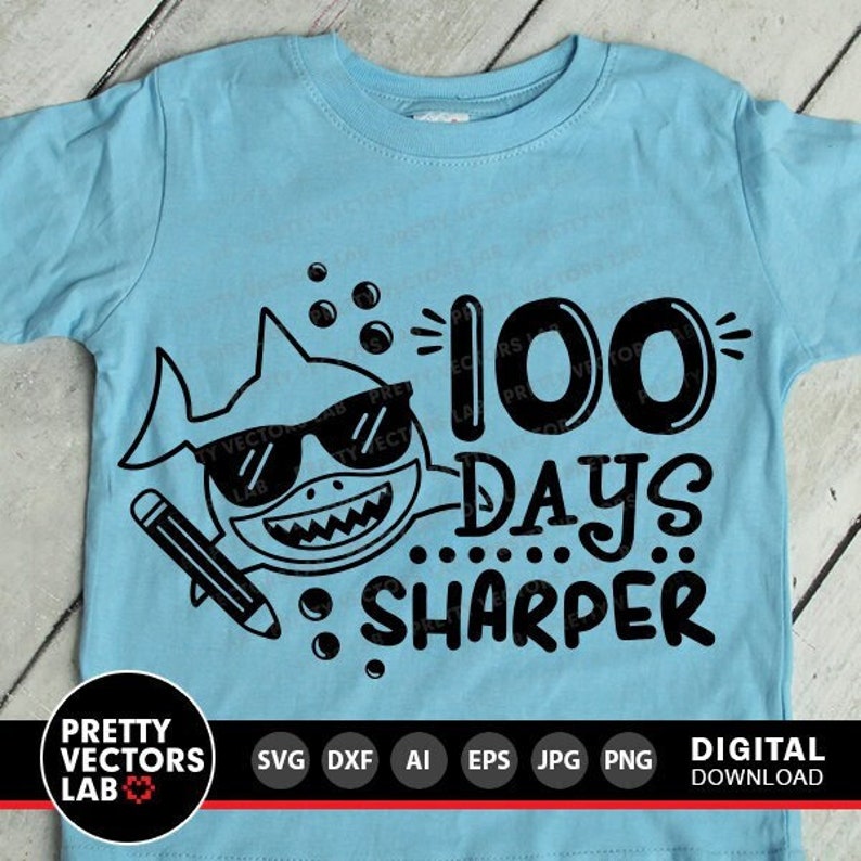 May include: A light blue t-shirt with a black shark graphic and the text "100 Days Sharper".