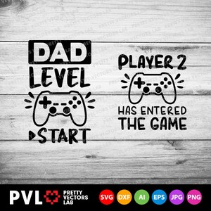 Op de afbeelding: Zwart-wit grafisch ontwerp met de tekst "Dad Level Start" en een videogamecontroller. Onder de controller bevindt zich een zwarte pijl die naar rechts wijst. De tekst "Player 2 Has Entered The Game" bevindt zich aan de rechterkant van de afbeelding met een videogamecontroller.