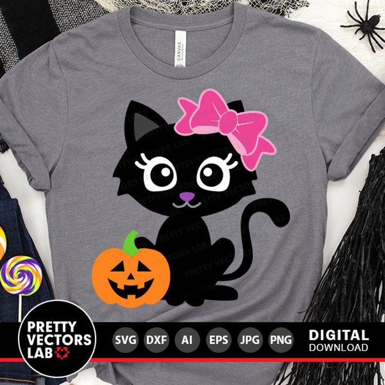 May include: A black cat with a pink bow holding a jack-o'-lantern. The cat has large eyes and a pink nose. The image is on a gray t-shirt.