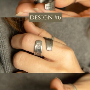 May include: A silver ring made from a spoon with a floral design. The ring is wrapped around the finger and is shown on a model's hand.