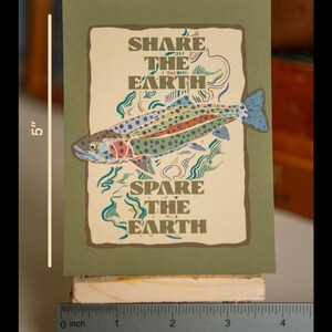 May include: A green card with a brown background featuring a colorful trout fish and the text "SHARE THE EARTH" and "SPARE THE EARTH". The card measures 3.75 inches by 5 inches.
