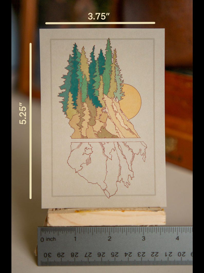 May include: A print of a forest scene with a sun setting behind a mountain range. The print is on a beige background and measures 3.75 inches wide by 5.25 inches tall.