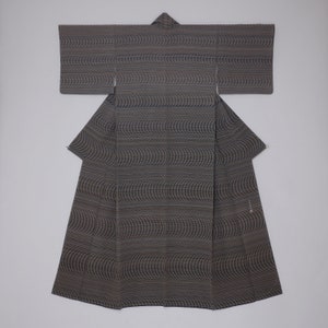 May include: A black and brown patterned kimono with a wavy design. The kimono is folded and laid flat on a white background.