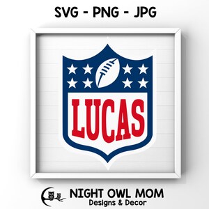 May include: A blue and red football-shaped shield with white stars and the name "LUCAS" in red letters. The shield is on a white background.