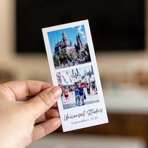 May include: A white photo strip featuring two images from Universal Studios. The top image shows a castle, and the bottom image shows a street scene. The text "Universal Studios September 2022" is printed on the bottom.