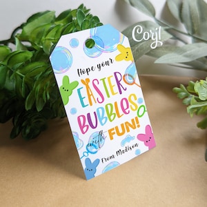 May include: A white gift tag with a colorful Easter theme. It features a cartoon bunny, bubbles, and the text "Hope your Easter Bubbles with FUN! From Madison".