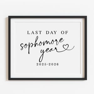 May include: A framed print with the text "LAST DAY OF sophomore year" in a stylish script font, with a heart symbol. The year "2025-2026" is printed below. The frame is black, and the background is white.