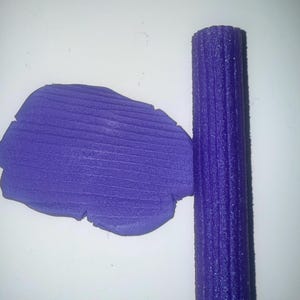 May include: A purple textured roller and a flat piece of purple textured clay.
