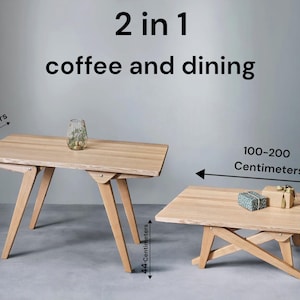 May include: Two wooden tables, one larger than the other, with a folding design. The larger table is 50-90 cm wide and 75 cm long. The smaller table is 100-200 cm wide and 44 cm long. The text "2 in 1 coffee and dining" is displayed above the tables.