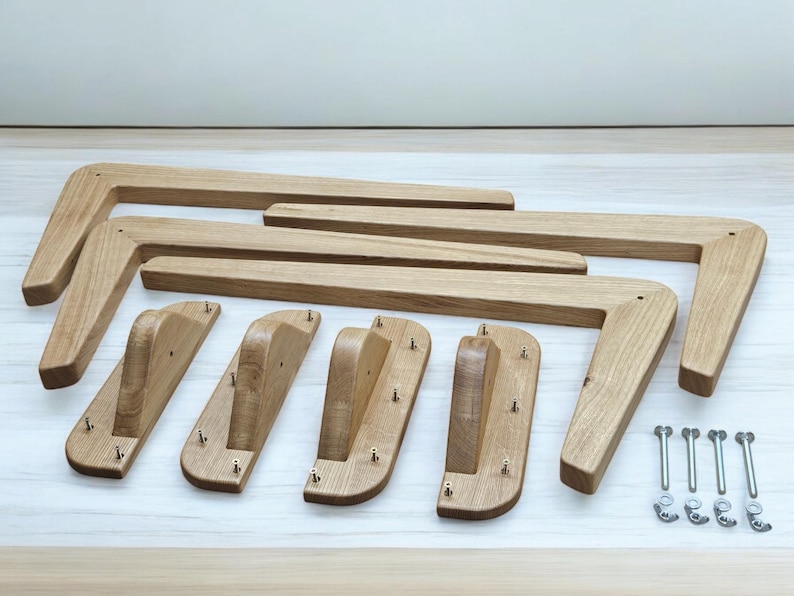 May include: Set of six wooden table legs with a curved design. The legs are made of light brown wood and have a natural finish. The set also includes four metal screws and four metal washers.