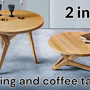 May include: Two wooden round tables with a unique folding design. The larger table is set for dining with two glasses and candles, while the smaller table is styled as a coffee table with a stack of books on top. The text "2 in 1 Dining and coffee table" is displayed below the tables.