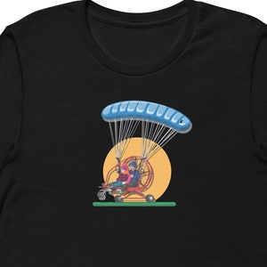 May include: Black t-shirt with a graphic of a person flying a paramotor with a blue parachute against a yellow sun.