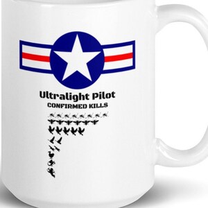 May include: White ceramic mug with a blue star and red and white stripes, the text "Ultralight Pilot CONFIRMED KILLS" and a graphic of a flock of birds.