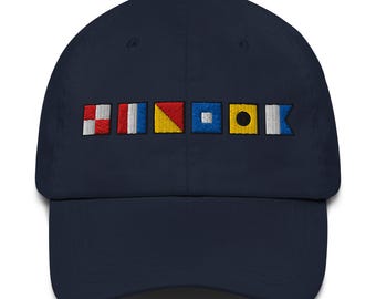 UTOPIA spelled out with Embroidered Nautical SignalFlags Dad hat, Text on back of hat