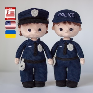 May include: Two handmade crochet dolls dressed as police officers. The dolls are wearing navy blue uniforms with black ties, hats, and badges. One doll has a cap with a badge, and the other has a hat that says "POLICE".