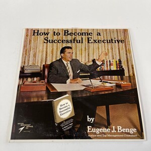 May include: A vintage record album cover featuring a man in a suit sitting at a desk. The album cover is titled "How to Become a Successful Executive" by Eugene J. Benge, Author and Top Management Consultant.