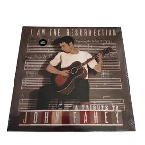 May include: A vinyl record titled "I Am The Resurrection: A Tribute to John Fahey." The album cover features an illustration of a man playing an acoustic guitar, set against a backdrop of musical notes and chord notations. The color palette is primarily brown and beige.