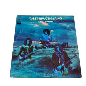 May include: A vintage vinyl record album cover featuring a band called "West, Bruce & Laing" with the album title "Why Dontcha". The cover art features three musicians in a blue and white seascape.