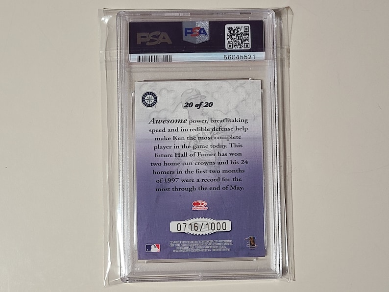 May include: A graded baseball card featuring Ken Griffey Jr. in a Seattle Mariners uniform. The card is numbered 0716/1000 and is part of a 20-card set. The back of the card features a description of Griffey's career highlights.