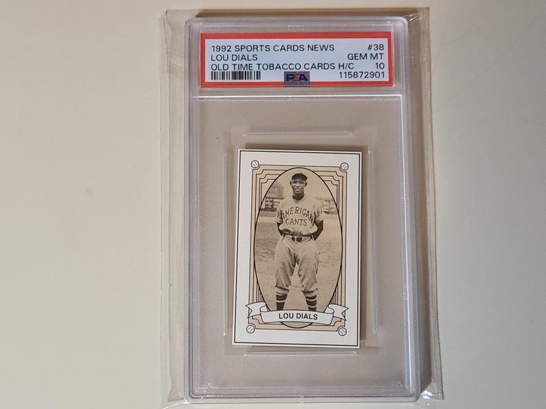 May include: A vintage baseball card featuring Lou Dials of the American Giants, encased in a protective holder. The card is from the 1992 Sports Cards News series, graded GEM MT 10. The card has a sepia tone and includes the text "LOU DIALS".