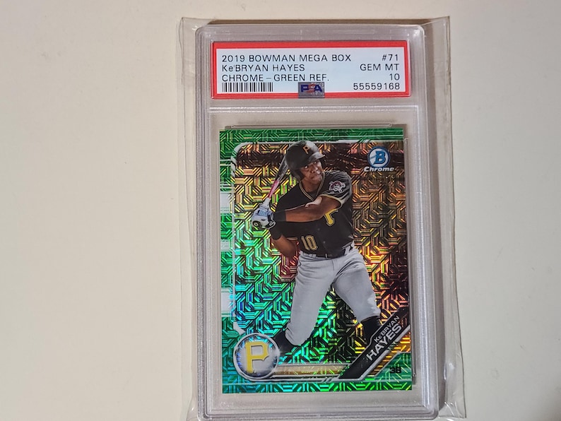 Puede incluir: Una tarjeta de b&eacute;isbol de Ke'Bryan Hayes del set 2019 Bowman Mega Box. La tarjeta est&aacute; calificada como GEM MT 10 y presenta un acabado cromado verde. La tarjeta est&aacute; dentro de una funda protectora de pl&aacute;stico.