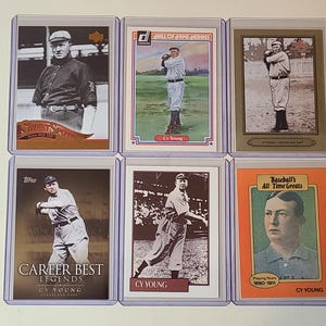 May include: Six baseball trading cards featuring Cy Young. The cards are in protective cases. The cards have images of Cy Young in various poses, with text including "Sweet Spot", "Hall of Fame Heroes", and "Career Best Legends".