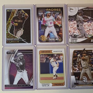 May include: A set of three ceramic mugs with a speckled, matte finish. The mugs are in shades of cream, light gray, and dark gray. Each mug has a simple, minimalist design, perfect for coffee or tea.