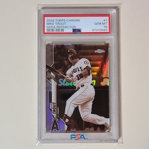 May include: A graded baseball card featuring Mike Trout of the Los Angeles Angels. The card is a 2020 Topps Chrome Sepia Refractor and is graded GEM MT 10 by PSA. The card is in a protective case.