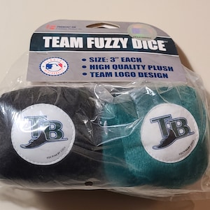 May include: Two plush dice with the Tampa Bay Rays logo. The dice are 3 inches in diameter and are made of high-quality plush. The dice are packaged in a clear plastic bag with a header card that says "Team Fuzzy Dice".