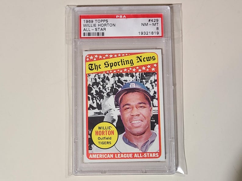 May include: A 1969 Topps baseball card featuring Willie Horton, an outfielder for the Detroit Tigers. The card is graded NM-MT 8 by PSA and has the number 429. The card features a photo of Horton in his Tigers uniform, with the text "The Sporting News" at the top and "Willie Horton, Outfield, Tigers" below the photo.