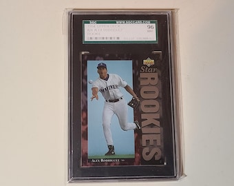 May include: A 1994 Upper Deck Alex Rodriguez rookie baseball card graded 96 Mint by SGC. The card features a photograph of the player in a white Seattle Mariners uniform throwing a baseball, with the text Star ROOKIES and Alex Rodriguez.