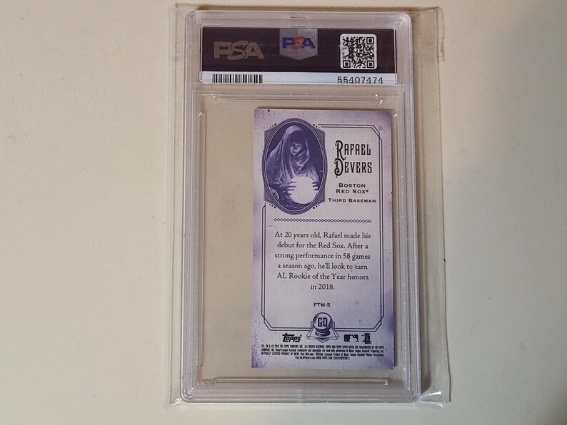 May include: A baseball card featuring Rafael Devers of the Boston Red Sox, encased in a protective plastic holder. The card has a vintage design with a portrait of Devers and biographical text. The card is graded by PSA.