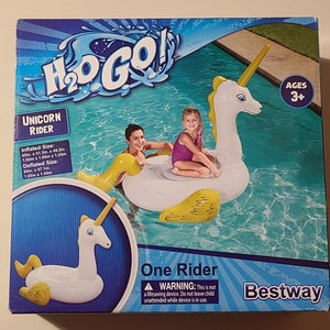 May include: A white inflatable unicorn pool float with yellow wings and a horn. The float is designed for one rider and is suitable for ages 3 and up. The packaging includes a warning that the float is not a lifesaving device and children should not be left unattended while using it.