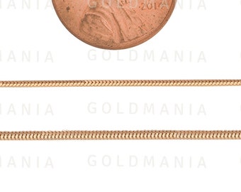 Pode incluir: Um colar de corrente de cobra de ouro com acabamento brilhante. A corrente é mostrada ao lado de um centavo americano para comparação de tamanho.