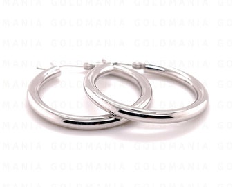 May include: A pair of silver hoop earrings. The hoops are thick and have a smooth, polished finish.