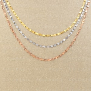 May include: Three layered necklaces with a delicate chain design. The top layer is gold, the middle layer is silver, and the bottom layer is rose gold.