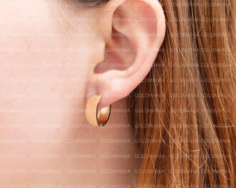 May include: A pair of gold hoop earrings. The earrings are simple and elegant, and they would be a great addition to any jewelry collection.