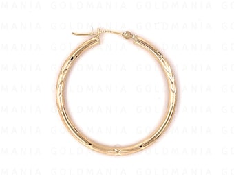 May include: A pair of gold hoop earrings with a textured design. The earrings are circular and have a smooth finish.